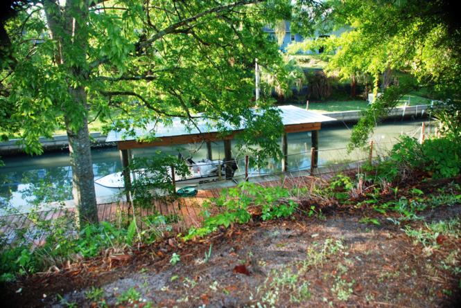 Shade trees at the back of the lot overlook the dock